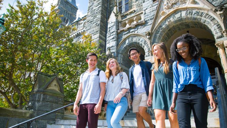 Students walking down Healy Hall's steps