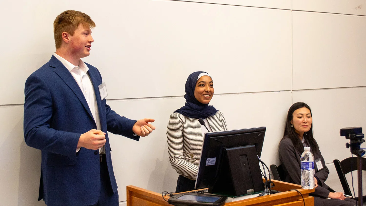 Student presenters stand at the podium during the "Food as Medicine" conference.
